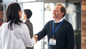 Businessman Shaking Hands With Attendee